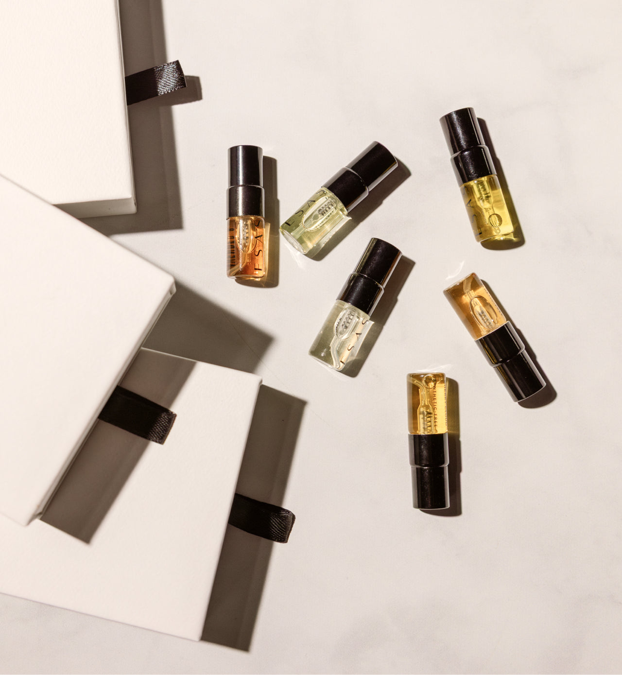 Six ESAS fragrance vials laid out beside the discovery kit boxes
